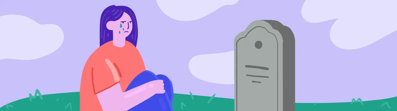 Une femme adulte vivant un deuil traumatique, en pleurs devant une tombe